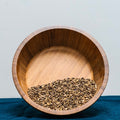 Milk Thistle Seeds (Silybum Marianum) in wooden bowl